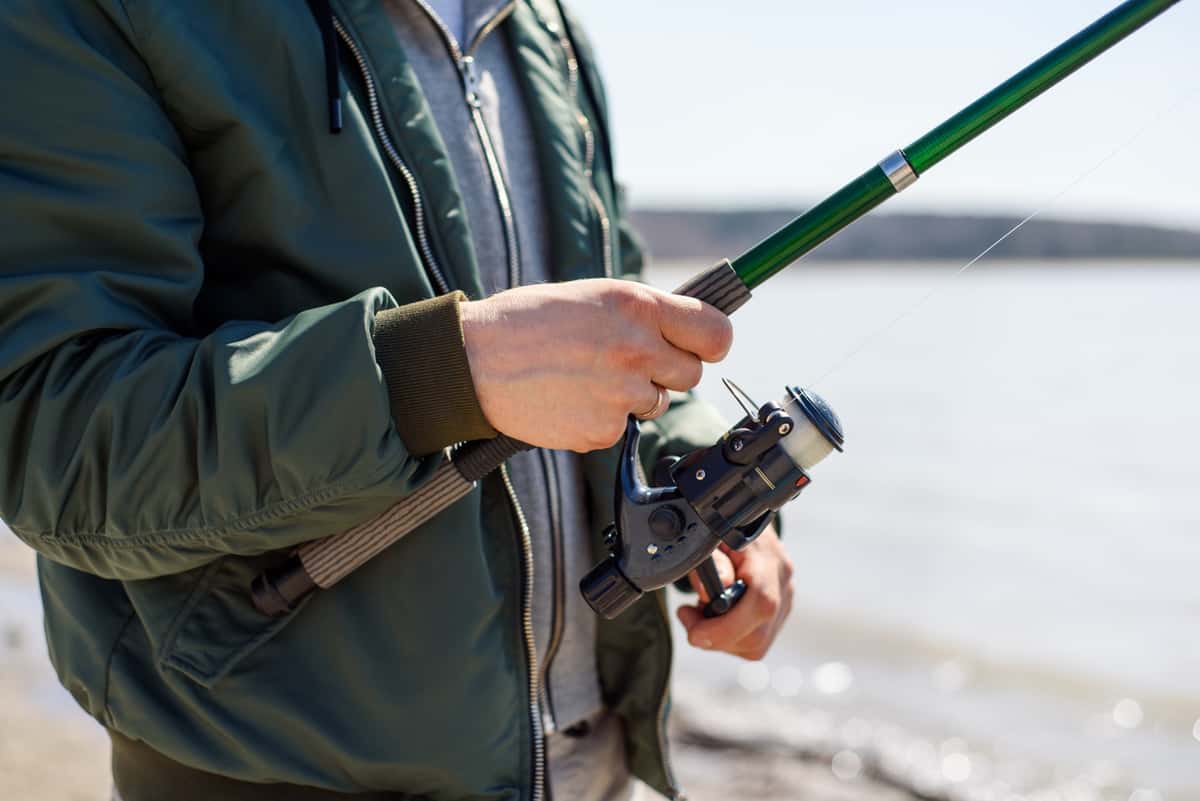 Man Holding Rod & Reel